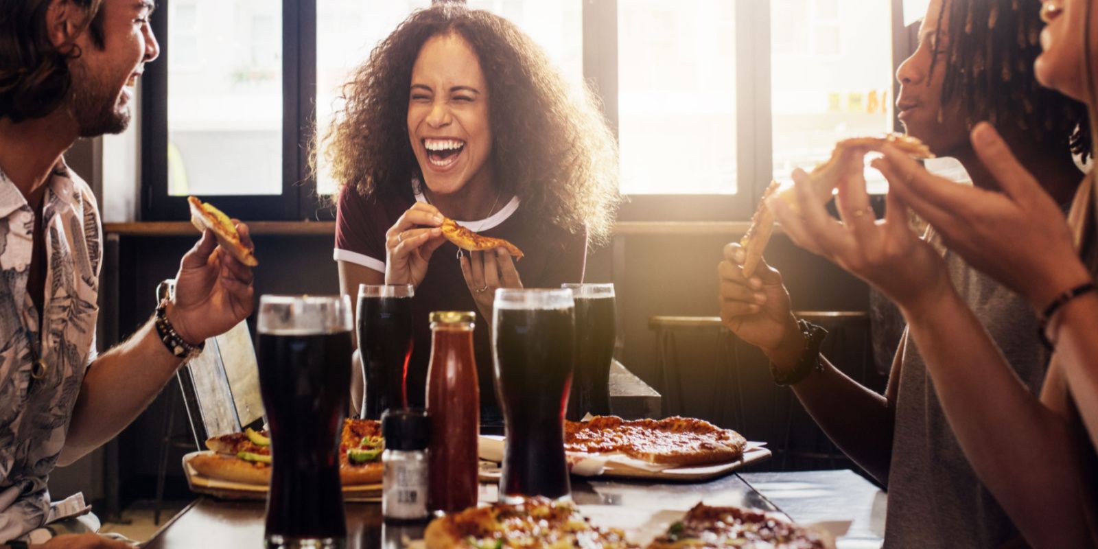 friends enjoying their pizza near our Gulf Shores rentals